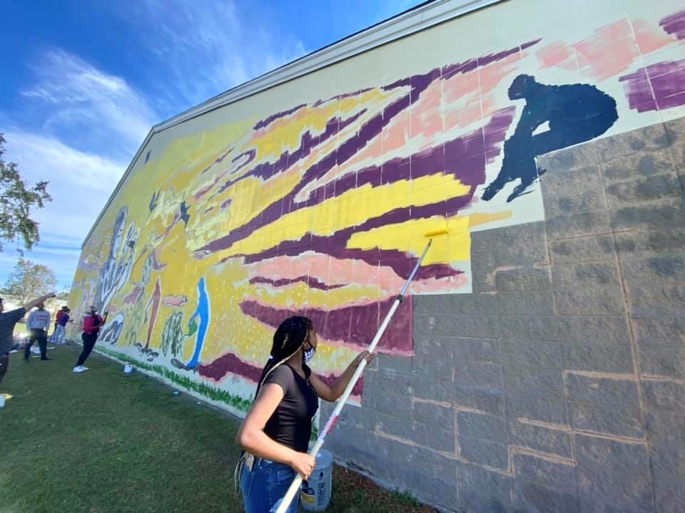 people painting mural