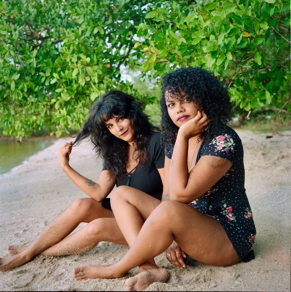 two people sitting on beach