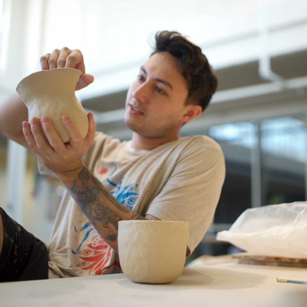 man making pottery