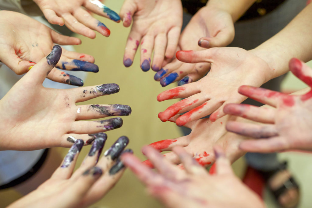 people with paint on hands