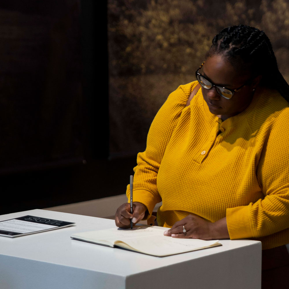 woman writing in book