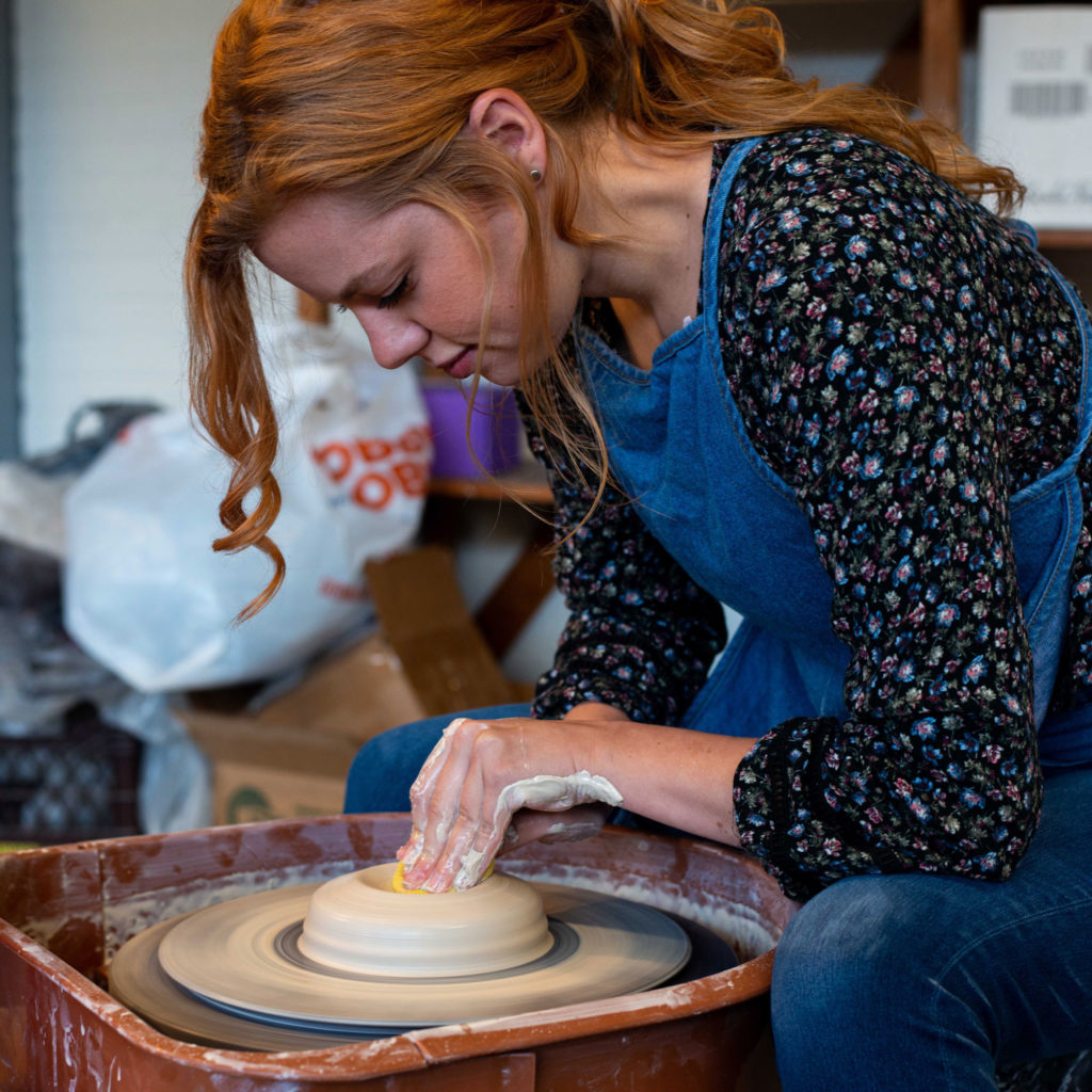 woman throwing pottery