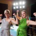 two women flexing biceps