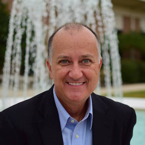 man in front of water fountain