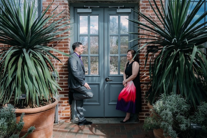 two people conversing outside of door