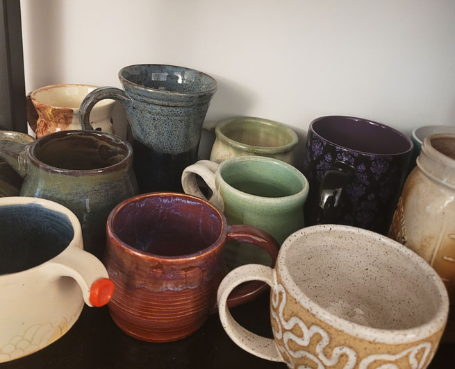 Assortment of handmade clay mugs