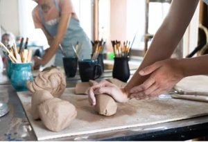 Artists rolling out clay