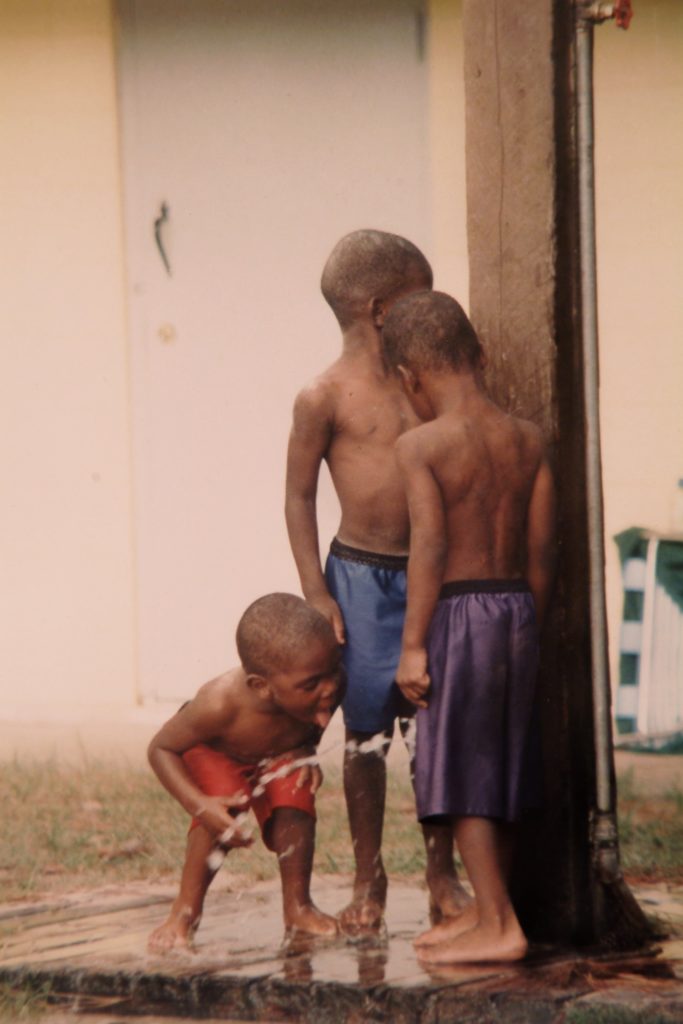 photograph by Ransom Phelps of three young African American boys playing in water