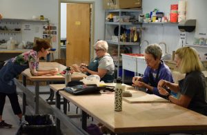 MMofA Students practicing molding pottery clay