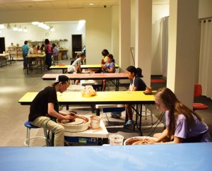 Teen Students at Mobile Museum of Art learning how to throw on the pottery wheel