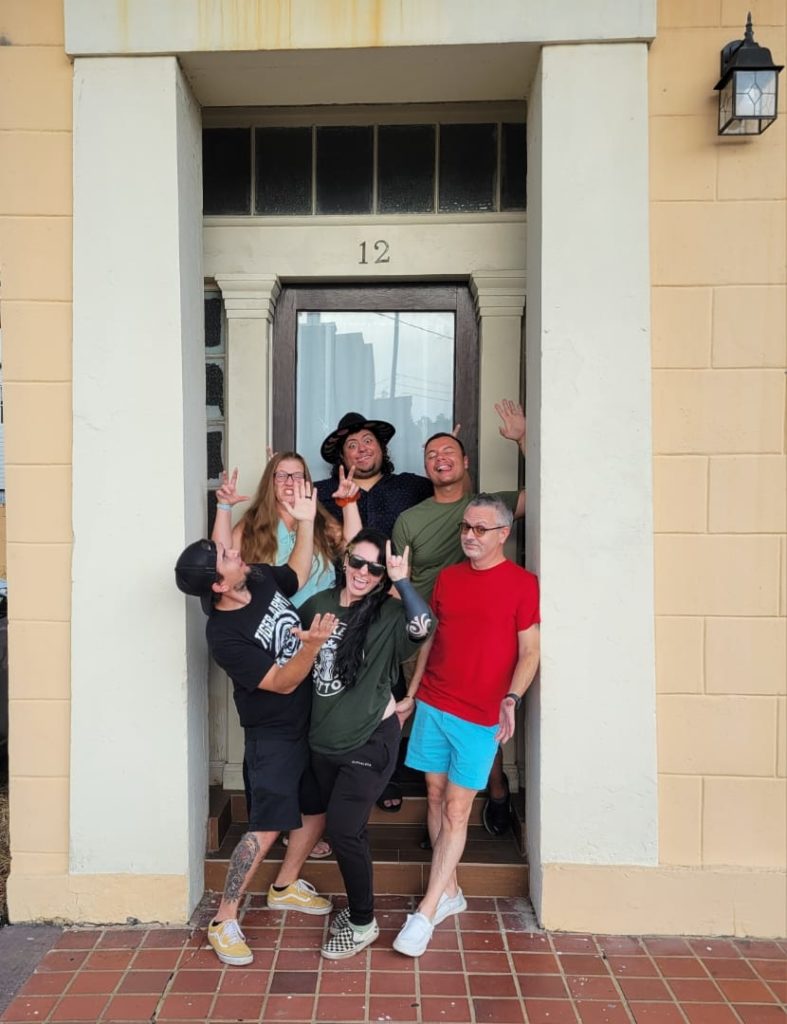 Small business owners gathered in doorway of The Frenchmen