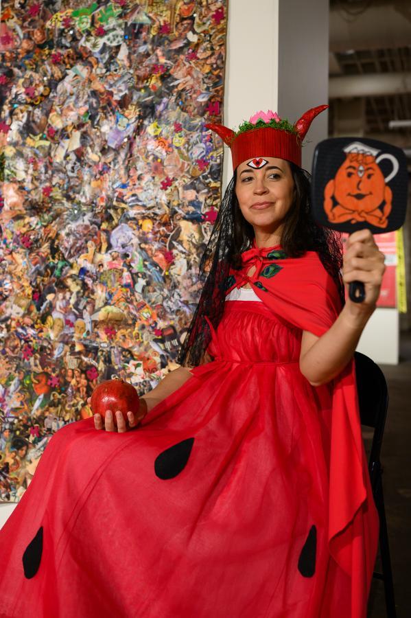 Katie Vogtner in modeling in NeuDawn experience wearing costume by MarLo Lombardi in front of a painting by Ryan Jetten and photographed by Richard Dollison