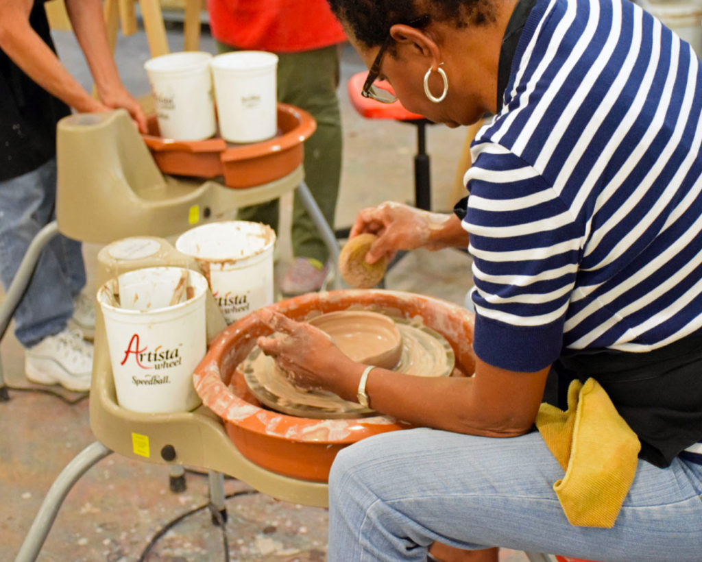 Mobile Museum of Art Member utilizing the pottery wheel