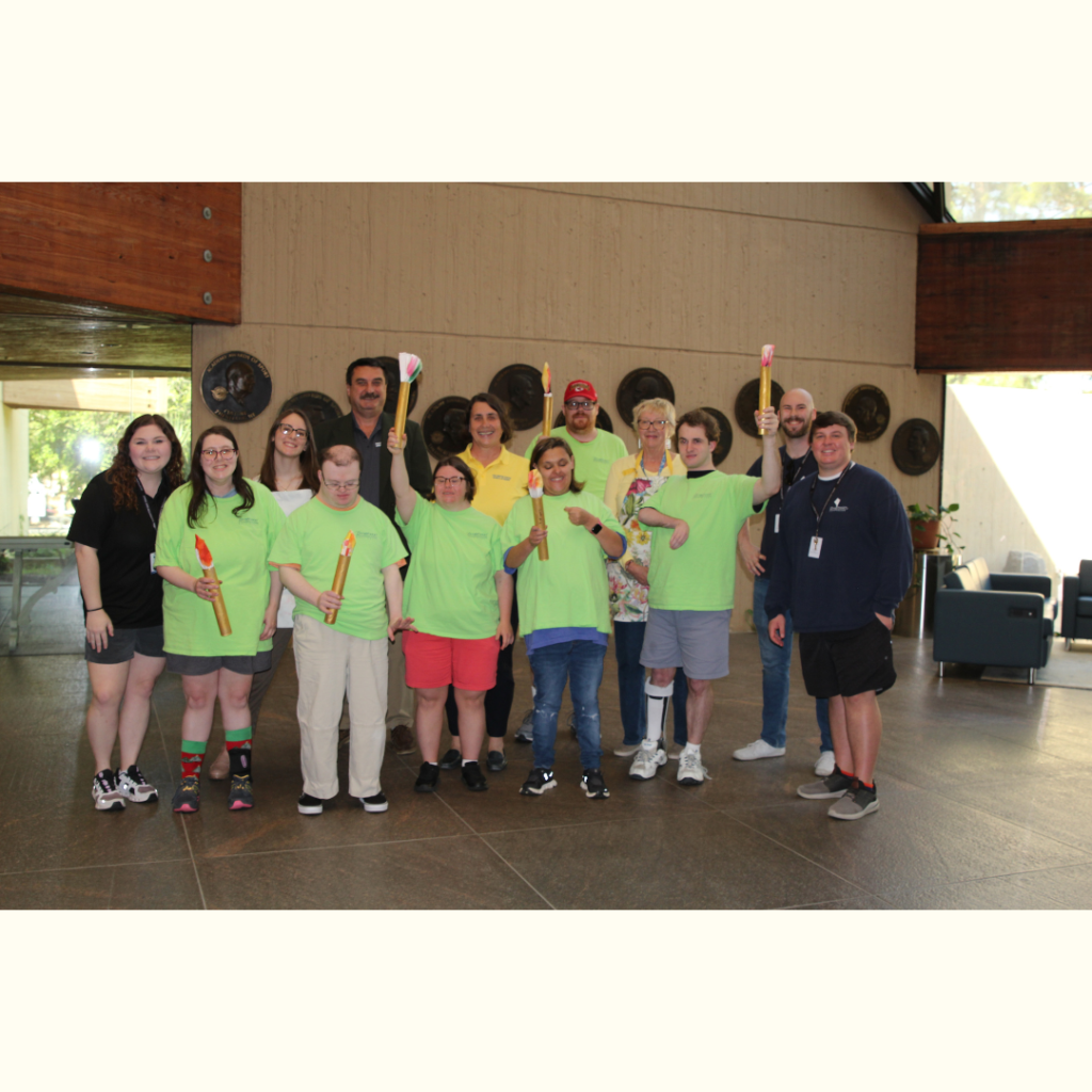 Group with Olympic torch art p[roject in lobby of United States Sports Academy