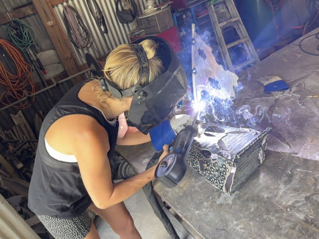 Laura Ledbetter welding in shop studio