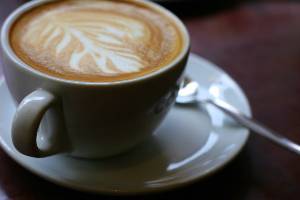 Coffee cup on saucer plate with spoon