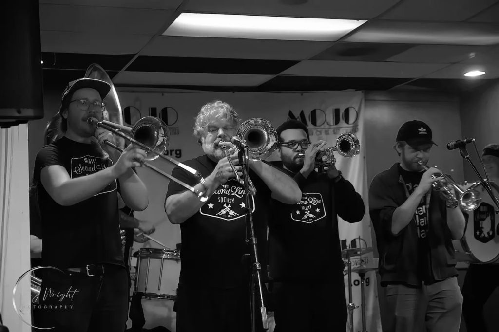 Horns section performing jazz at MOJO festival