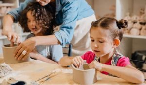 Young children sculpting with clay