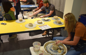 Adults on pottery wheel