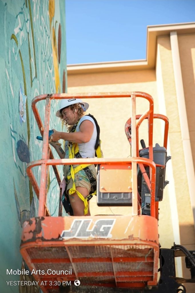 Hannah Legg working on a mural