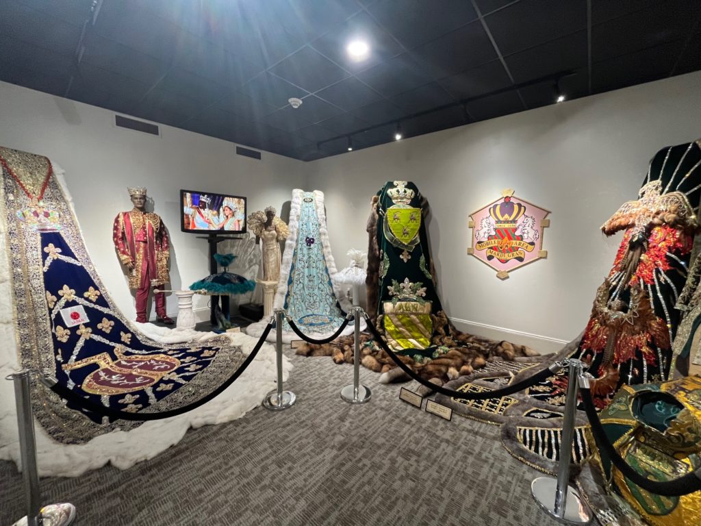 Views inside exhibition of Mardi Gras royalty wardrobe at Mobile Carnival Museum 