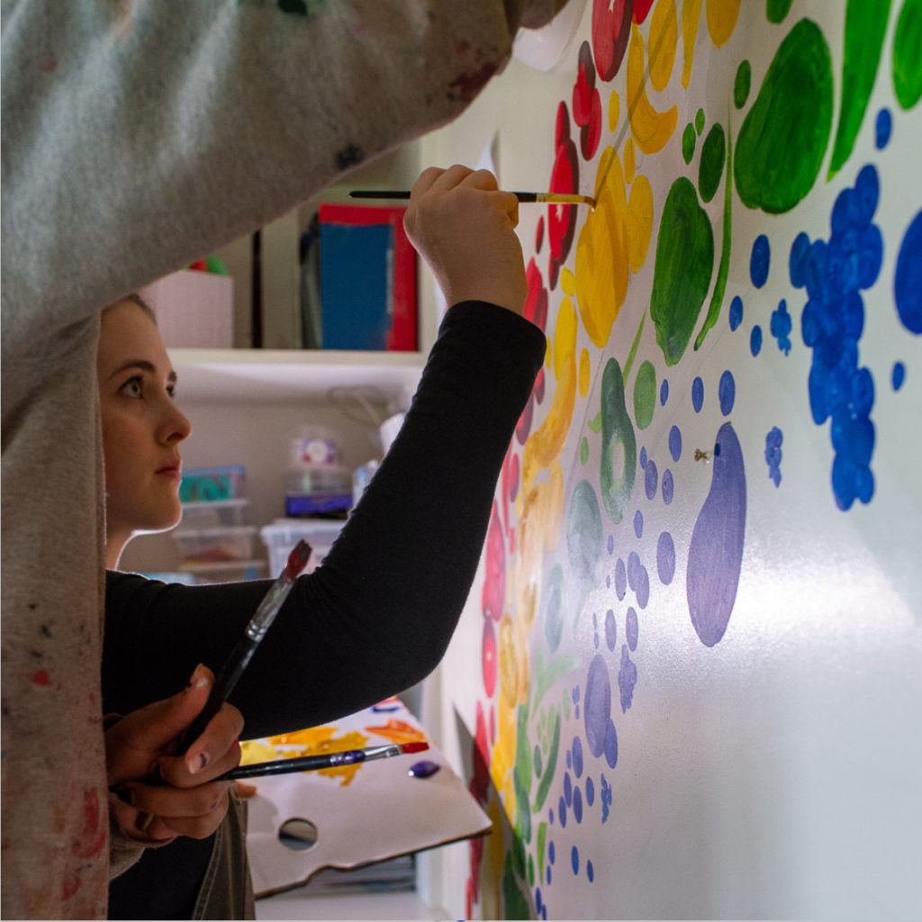 artist member of the month Phoebe Graham painting mural